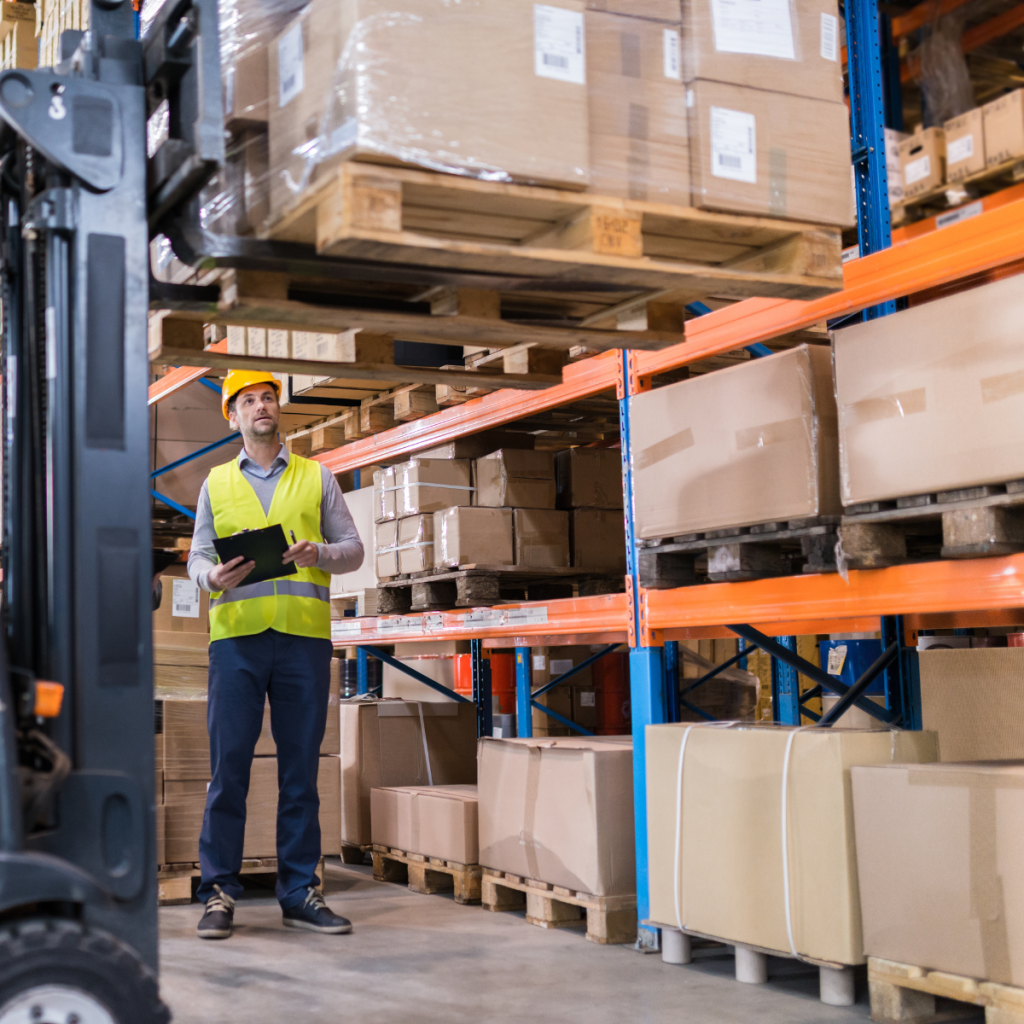 Business owner conducting an end-of-financial-year stocktake and inventory audit in a warehouse.